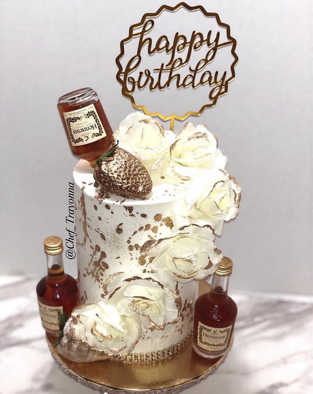 Custom Hennessy birthday cake with gold accents and white roses